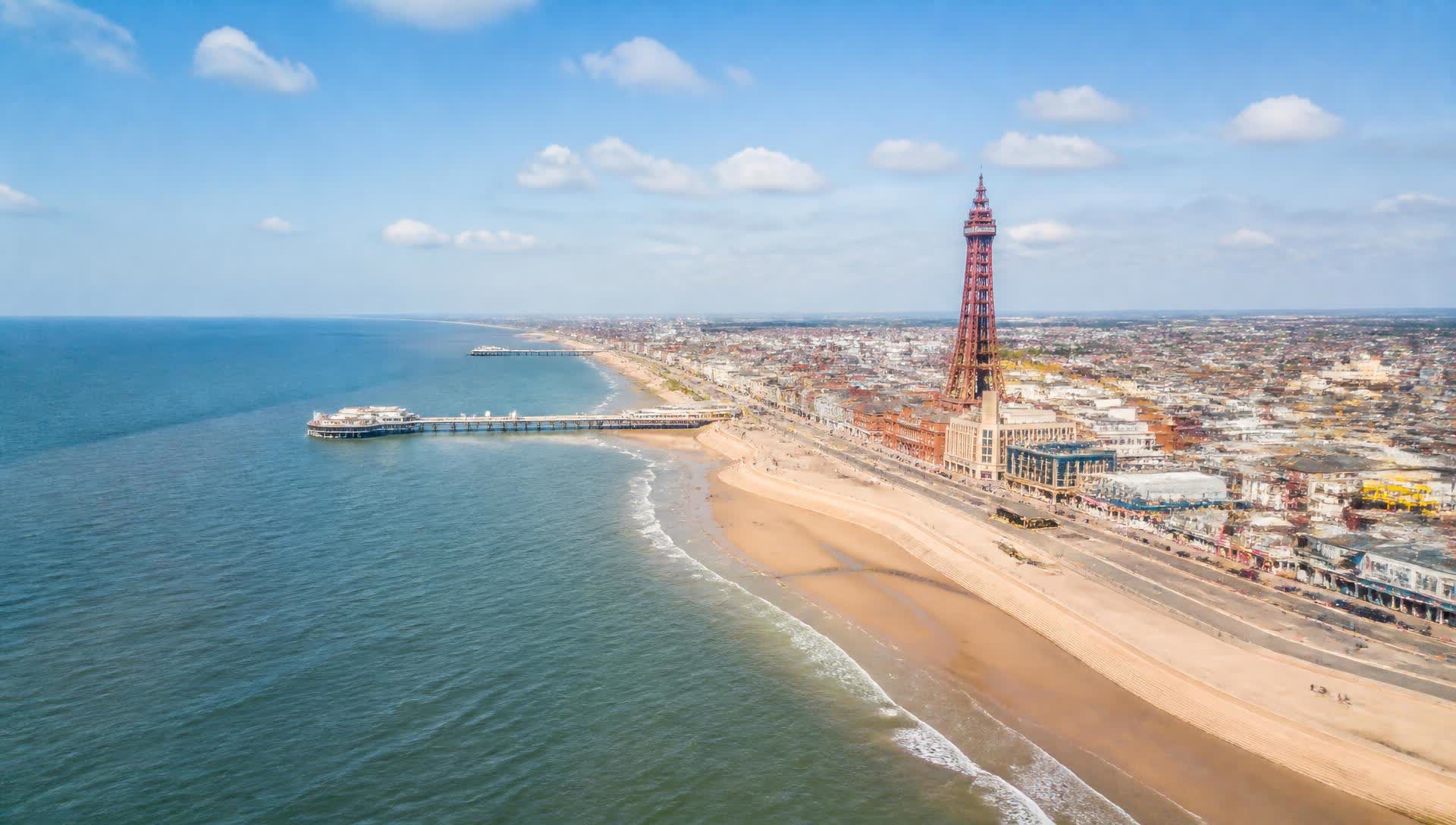A sunny aerial view of Blackpool Tower, the beach and coastline